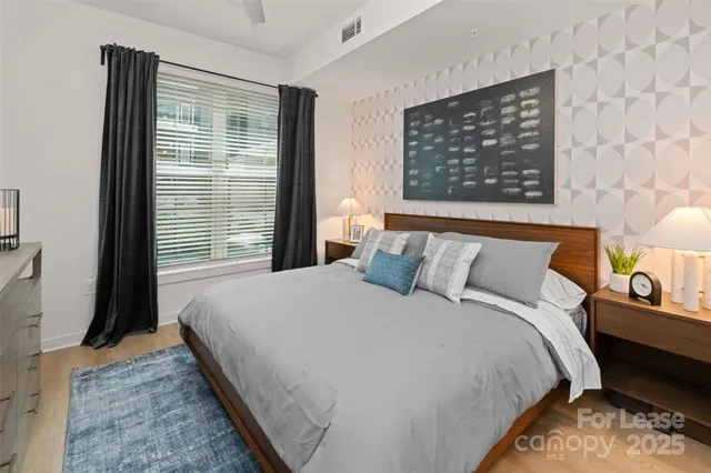 a bed sitting in a bedroom next to a window