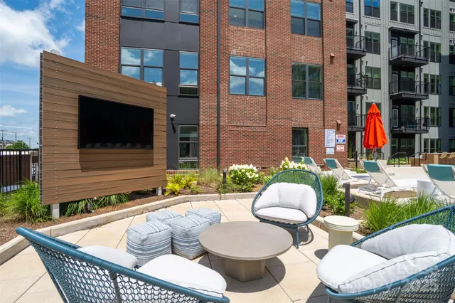 a view of a patio with couches table and chairs and potted plants