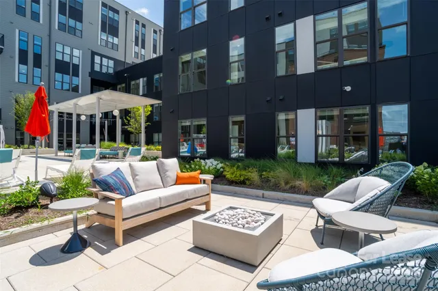 a view of a patio with couches and a table and chairs with plants