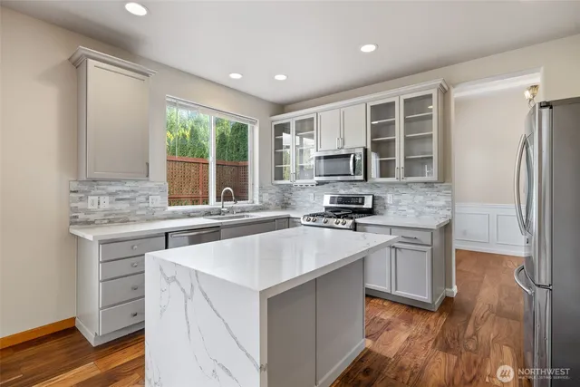 a kitchen with a sink stove and refrigerator