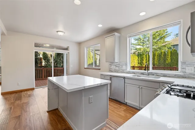a kitchen with a sink stove and cabinets