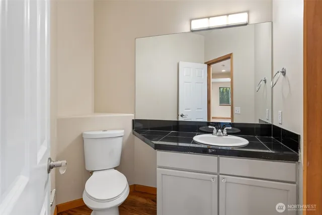a bathroom with a granite countertop sink and a mirror