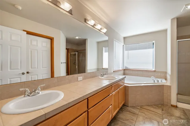 a bathroom with a bathtub and a shower