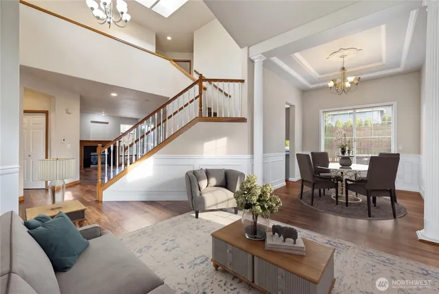 a living room with furniture and a dining table