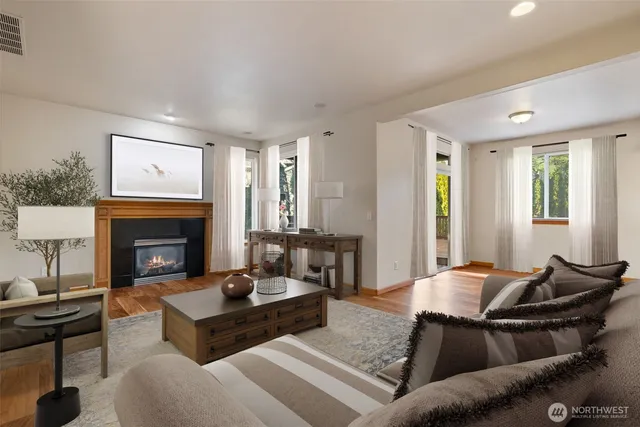 a living room with furniture a fireplace and window