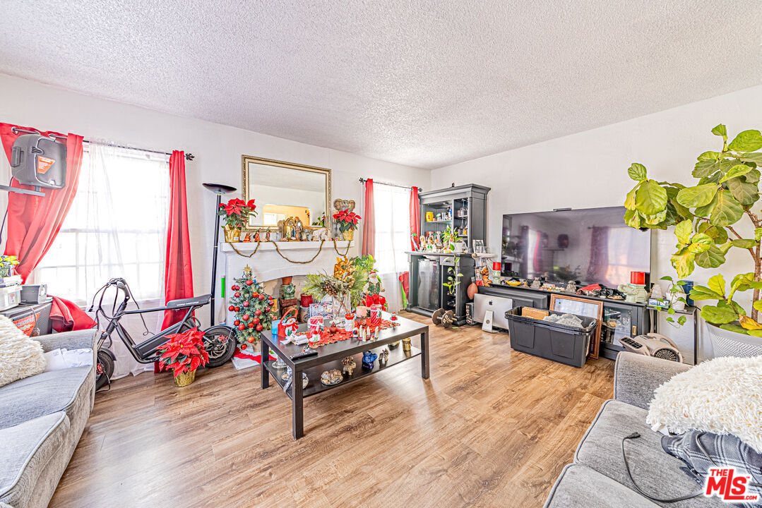 1618 South Burnside Avenue Los Angeles, CA 90019 - Photo 11 of 43 a living room with furniture and a wooden floor