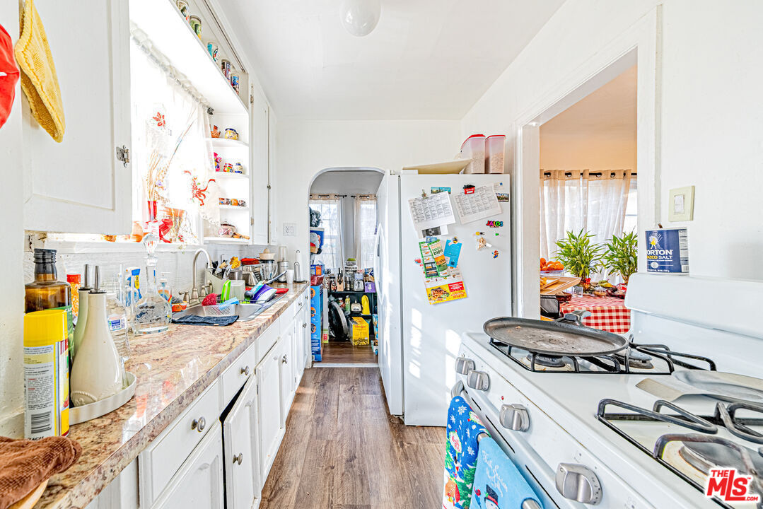 1618 South Burnside Avenue Los Angeles, CA 90019 - Photo 12 of 43 a view of a kitchen with fridge and stove