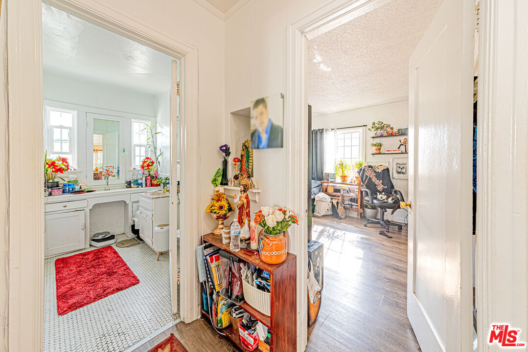 1618 South Burnside Avenue Los Angeles, CA 90019 - Photo 13 of 43 a view of a hallway with wooden floor and furniture