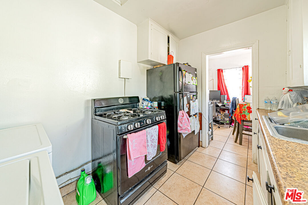 1618 South Burnside Avenue Los Angeles, CA 90019 - Photo 16 of 43 a kitchen with stainless steel appliances granite countertop a stove and a refrigerator