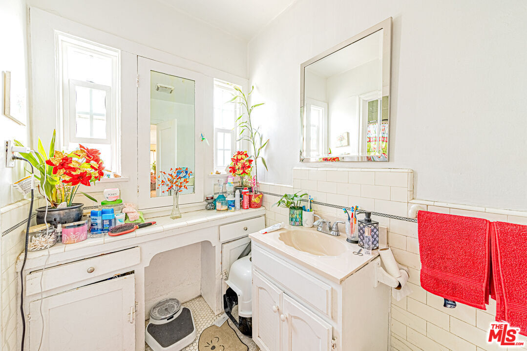 1618 South Burnside Avenue Los Angeles, CA 90019 - Photo 18 of 43 a bathroom with a sink mirror vanity and next to a window