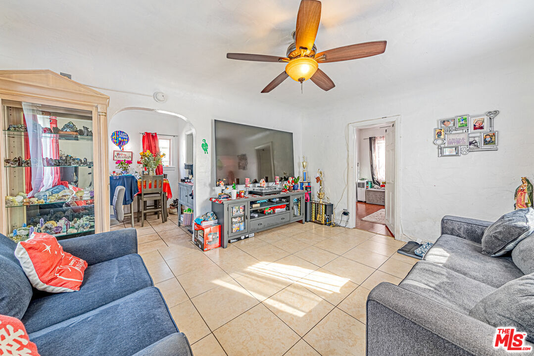 1618 South Burnside Avenue Los Angeles, CA 90019 - Photo 20 of 43 a living room with furniture and a flat screen tv