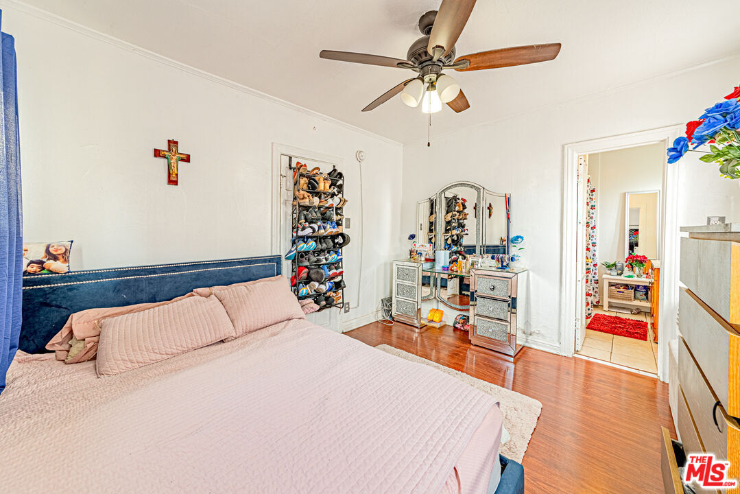 1618 South Burnside Avenue Los Angeles, CA 90019 - Photo 21 of 43 a bedroom with furniture and a wooden floor