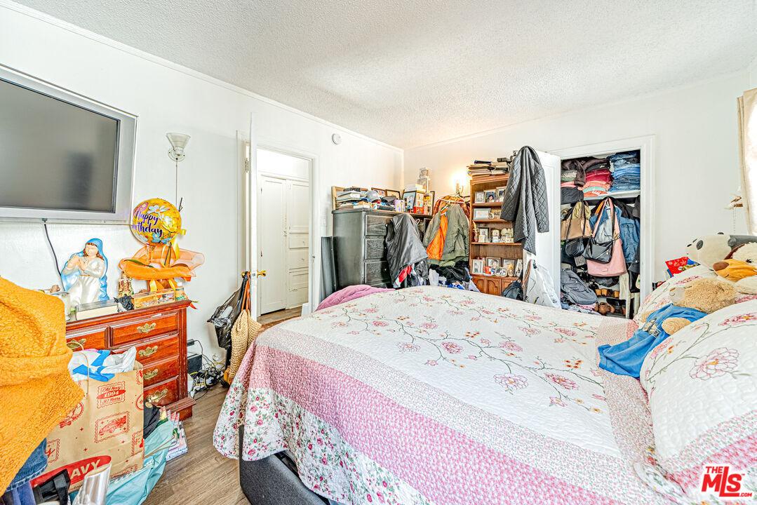 1618 South Burnside Avenue Los Angeles, CA 90019 - Photo 22 of 43 a bed room with a bed and a flat screen tv