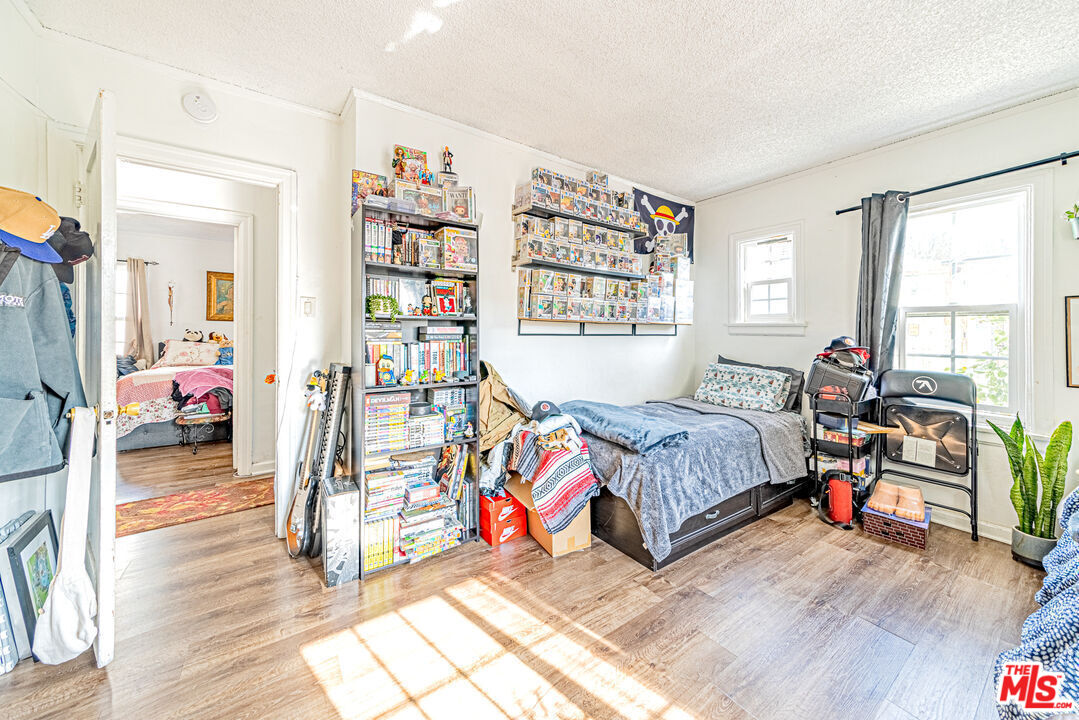 1618 South Burnside Avenue Los Angeles, CA 90019 - Photo 32 of 43 a bedroom with bed and a window