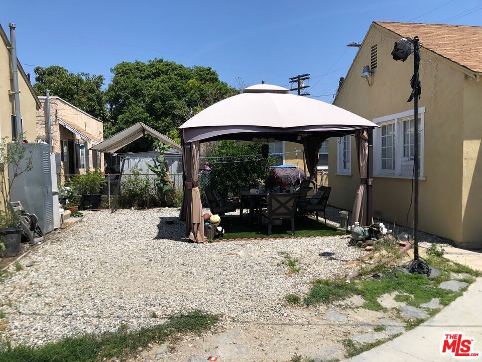 1618 South Burnside Avenue Los Angeles, CA 90019 - Photo 36 of 43 a view of a house with backyard porch and sitting area