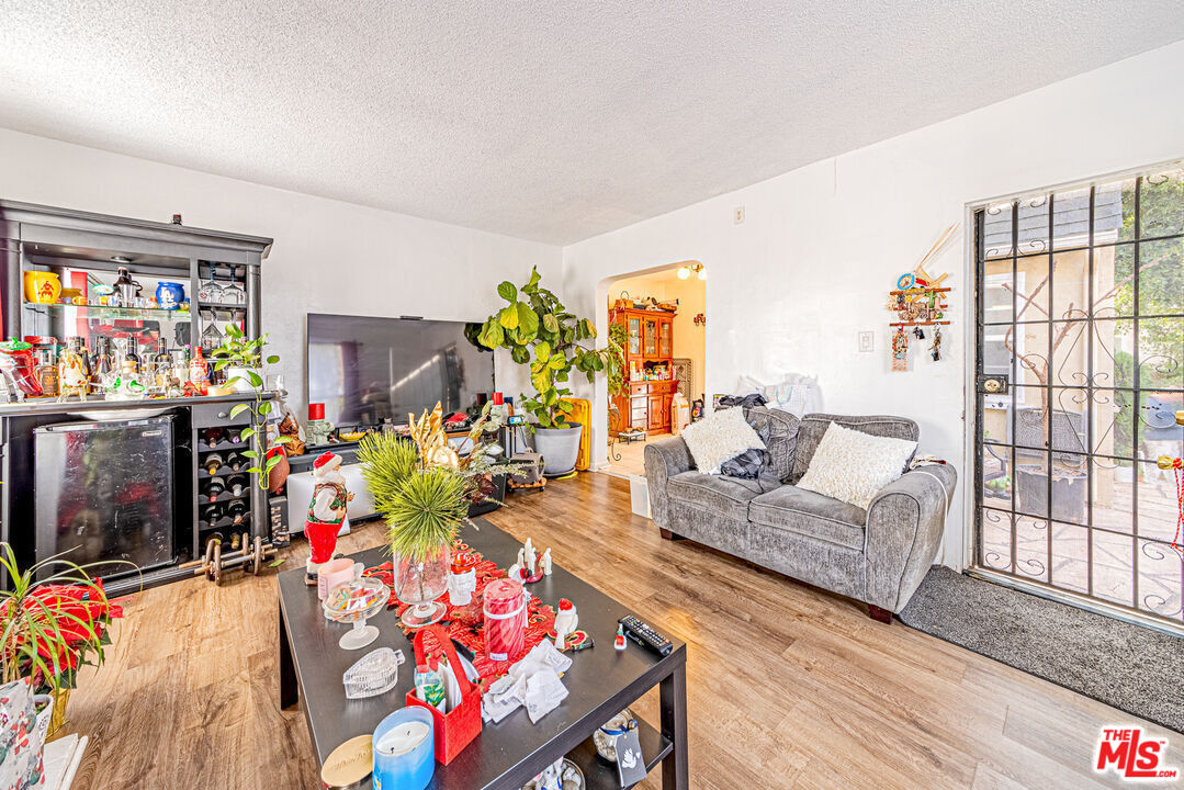 1618 South Burnside Avenue Los Angeles, CA 90019 - Photo 6 of 43 a living room with furniture and a floor to ceiling window