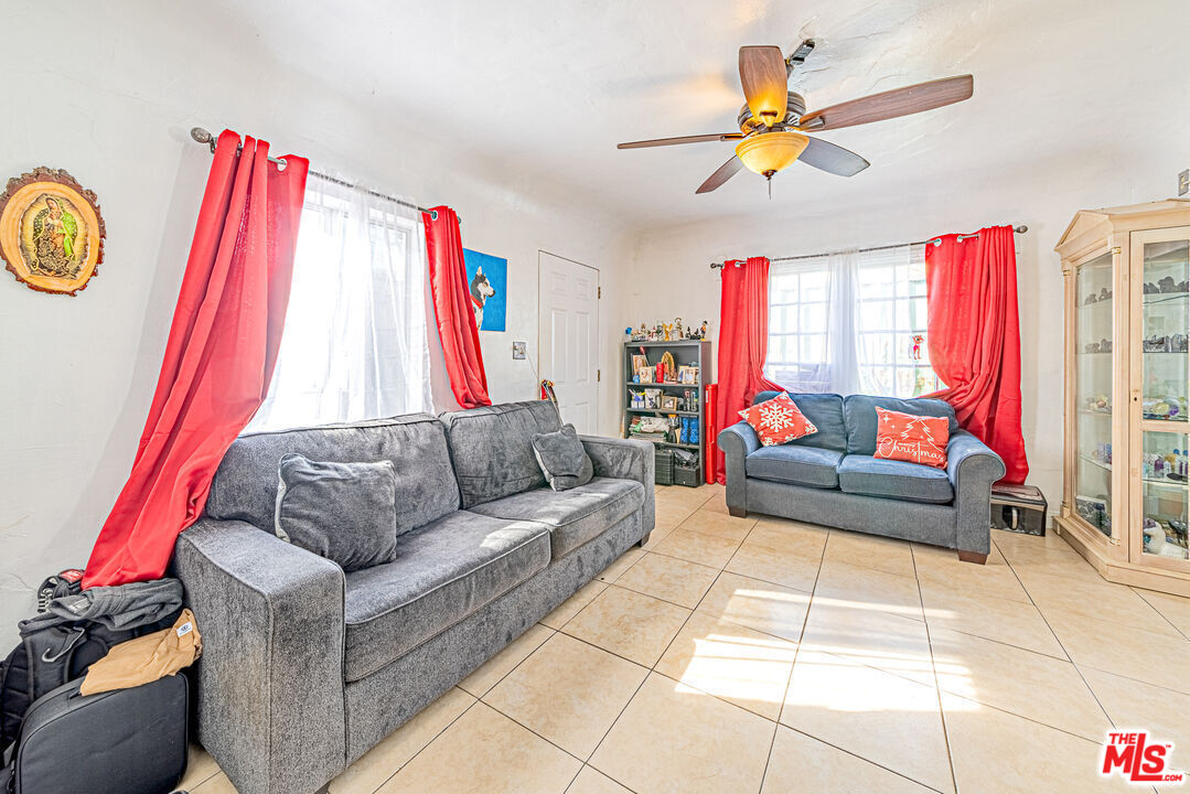 1618 South Burnside Avenue Los Angeles, CA 90019 - Photo 7 of 43 a living room with furniture and a flat screen tv