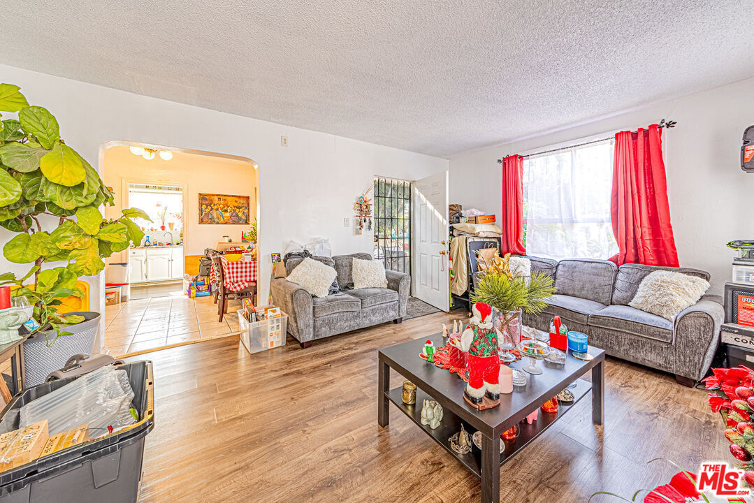1618 South Burnside Avenue Los Angeles, CA 90019 - Photo 8 of 43 a living room with furniture flat screen tv and a large window