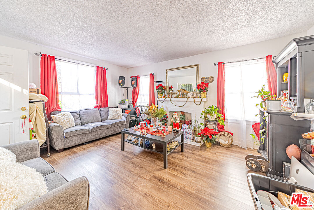 1618 South Burnside Avenue Los Angeles, CA 90019 - Photo 10 of 43 a living room with furniture and a wooden floor