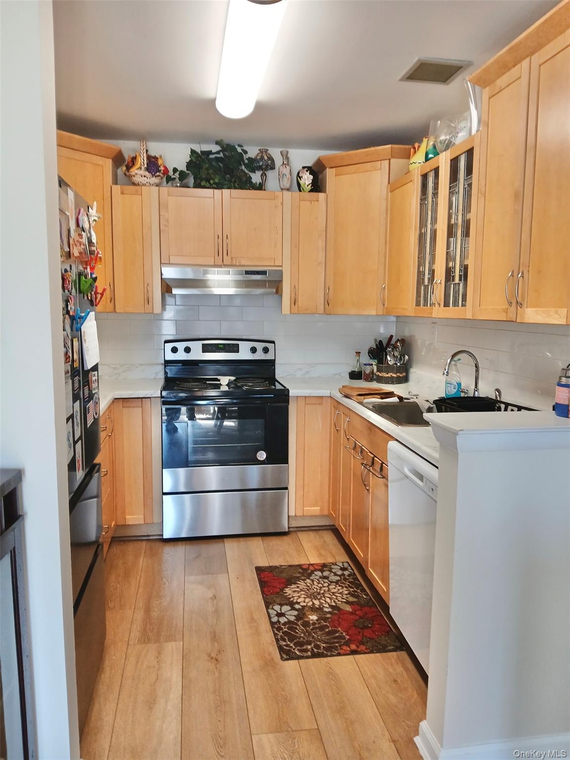 a kitchen with a stove a sink and a refrigerator