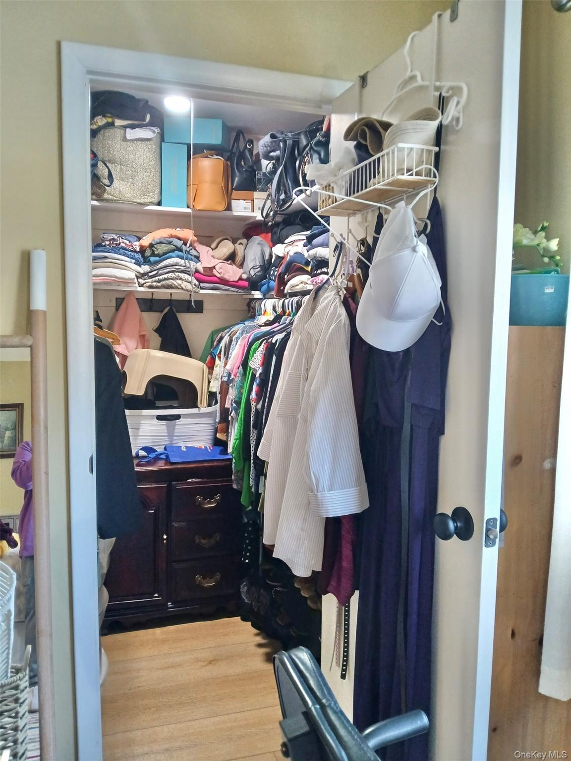 427 Aylesbury Court, Unit A Ridge, NY 11961 - Photo 11 of 16 a view of walk in closet with clothes and shoes