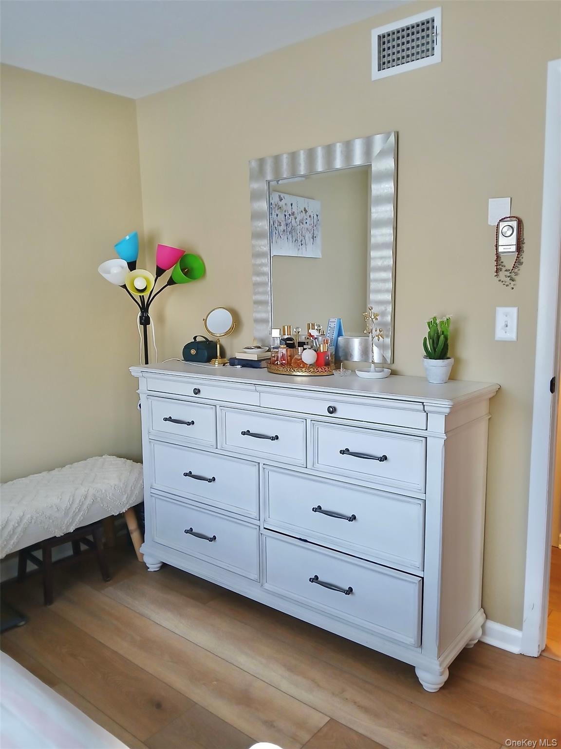 427 Aylesbury Court, Unit A Ridge, NY 11961 - Photo 14 of 16 a room with a dresser and a dresser