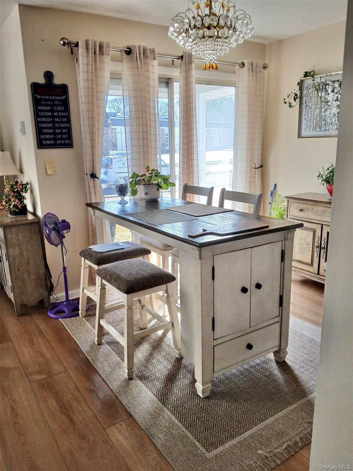 427 Aylesbury Court, Unit A Ridge, NY 11961 - Photo 4 of 16 a living room with granite countertop furniture a flat screen tv and a window