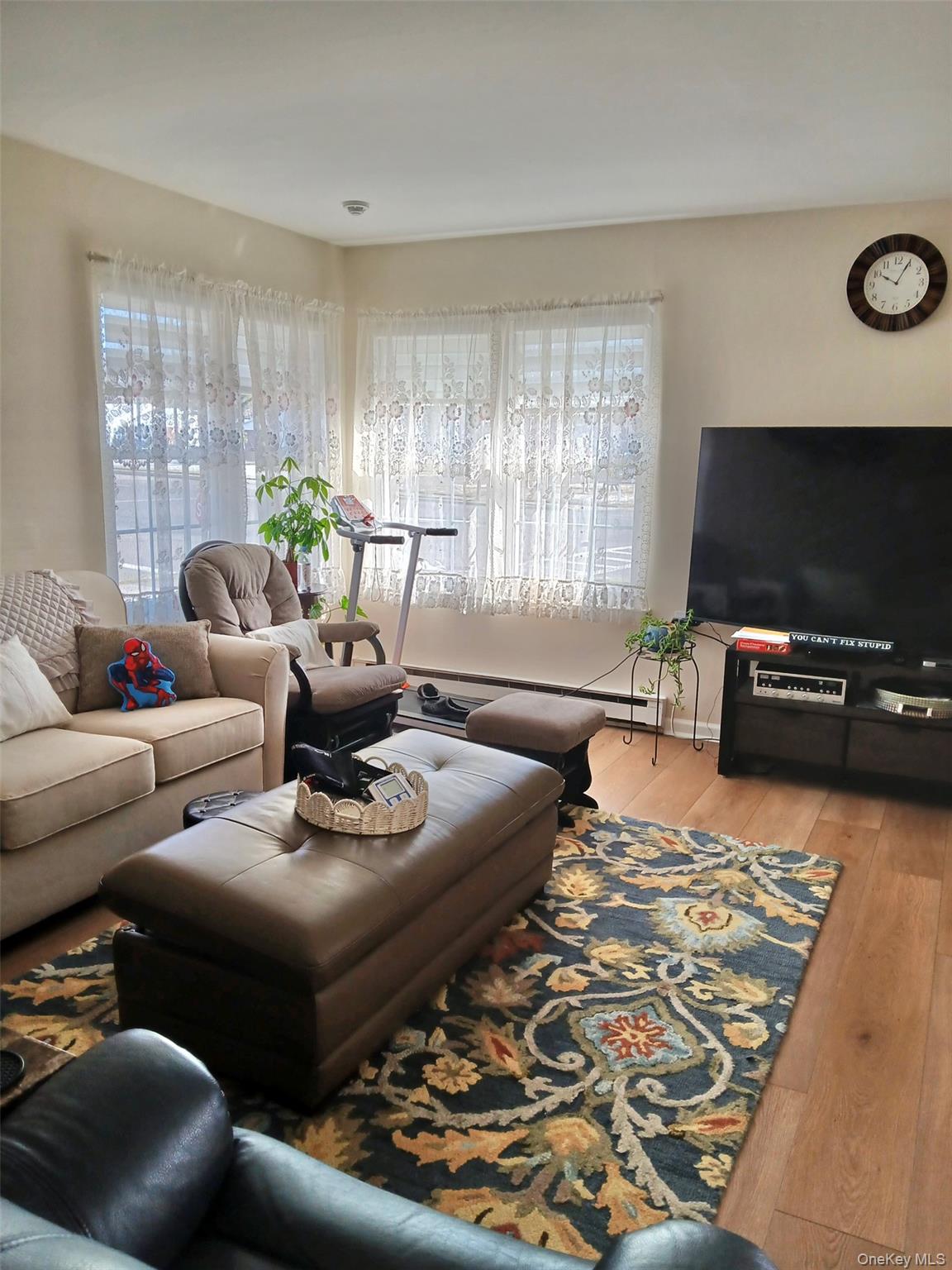 427 Aylesbury Court, Unit A Ridge, NY 11961 - Photo 7 of 16 a living room with furniture and a flat screen tv