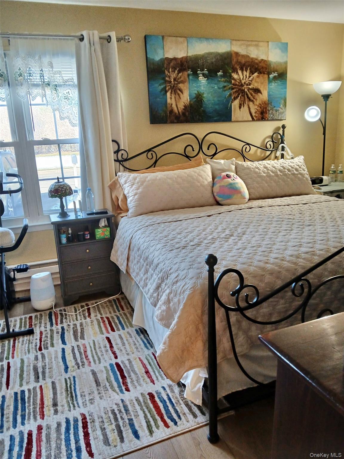 427 Aylesbury Court, Unit A Ridge, NY 11961 - Photo 9 of 16 a bedroom with a bed and wooden floor