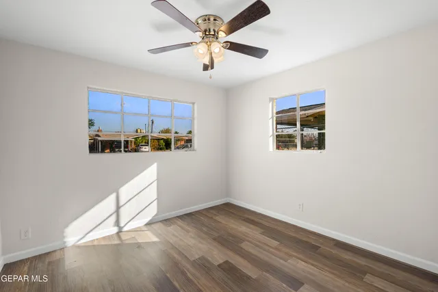 a view of a kitchen with an empty space and a ceiling fan