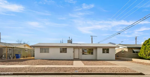 a front view of a house with a wooden fence