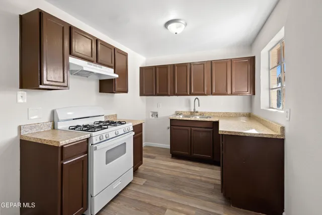 a kitchen with a stove and a sink