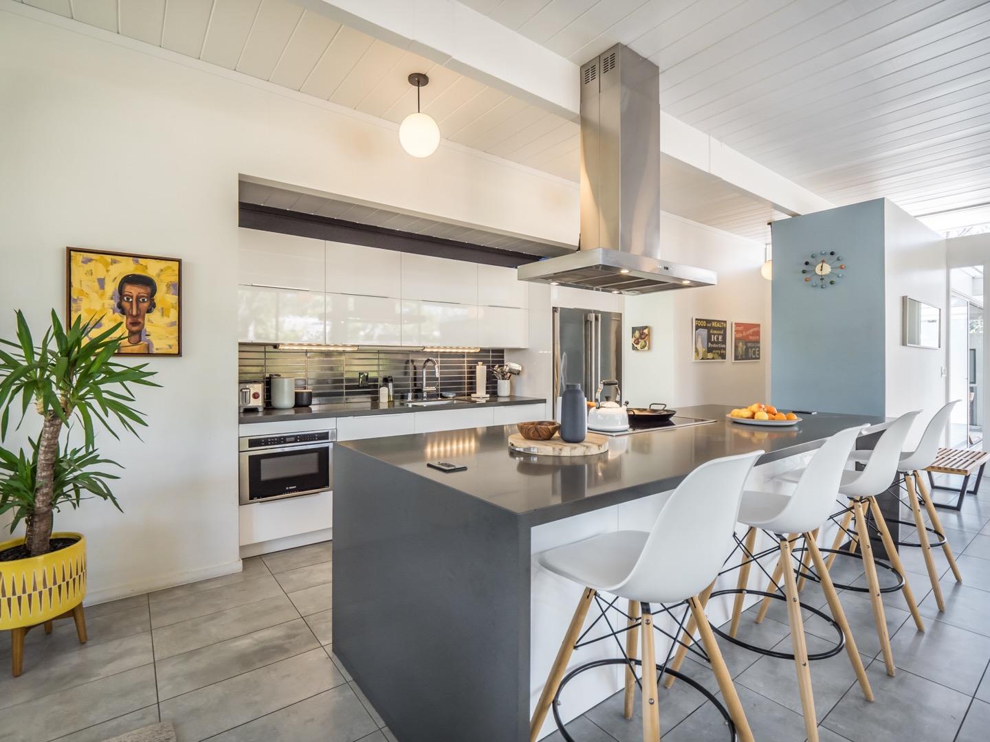3449 Thomas Drive Palo Alto, CA 94303 - Photo 12 of 59 a kitchen with stainless steel appliances kitchen island granite countertop a sink and cabinets
