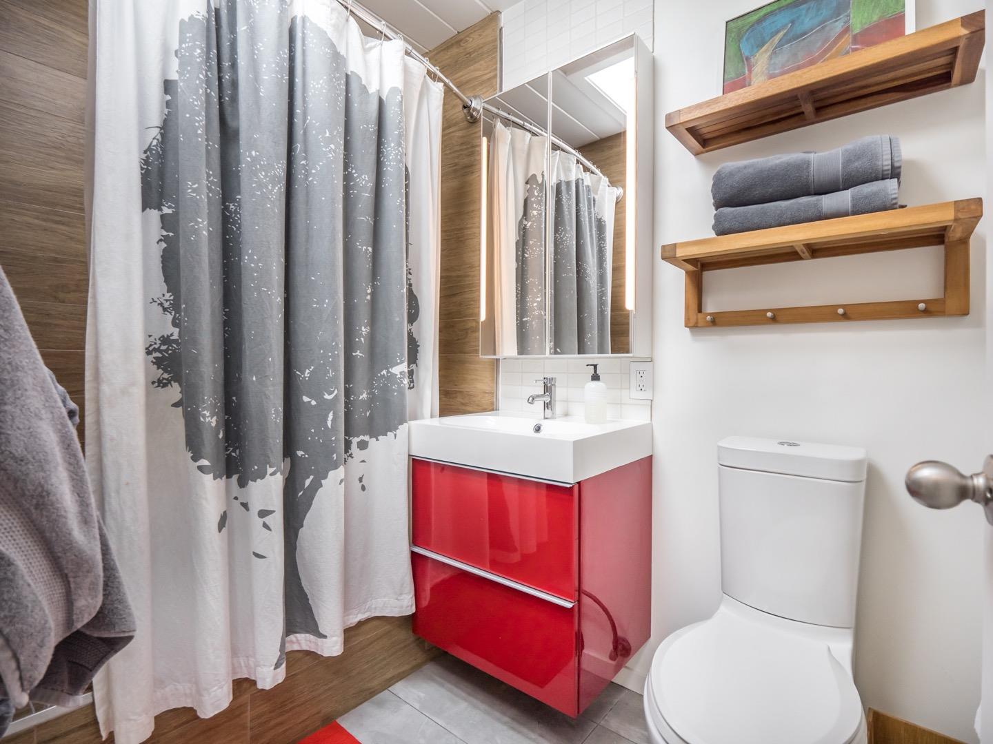 3449 Thomas Drive Palo Alto, CA 94303 - Photo 20 of 59 a bathroom with a sink vanity mirror and toilet