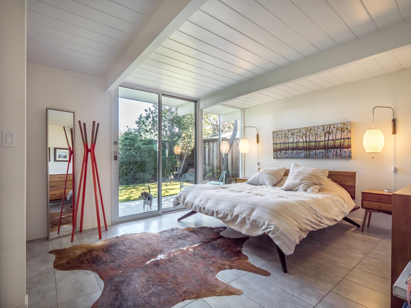 3449 Thomas Drive Palo Alto, CA 94303 - Photo 21 of 59 a bedroom with a bed and a wooden floor