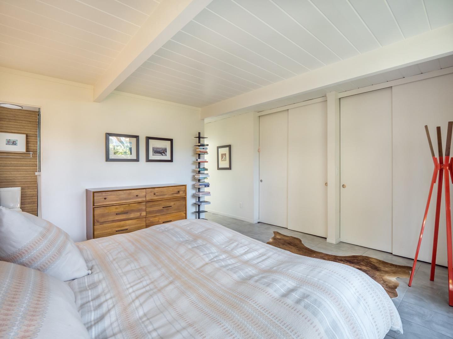 3449 Thomas Drive Palo Alto, CA 94303 - Photo 22 of 59 a bedroom with a large bed and a chandelier