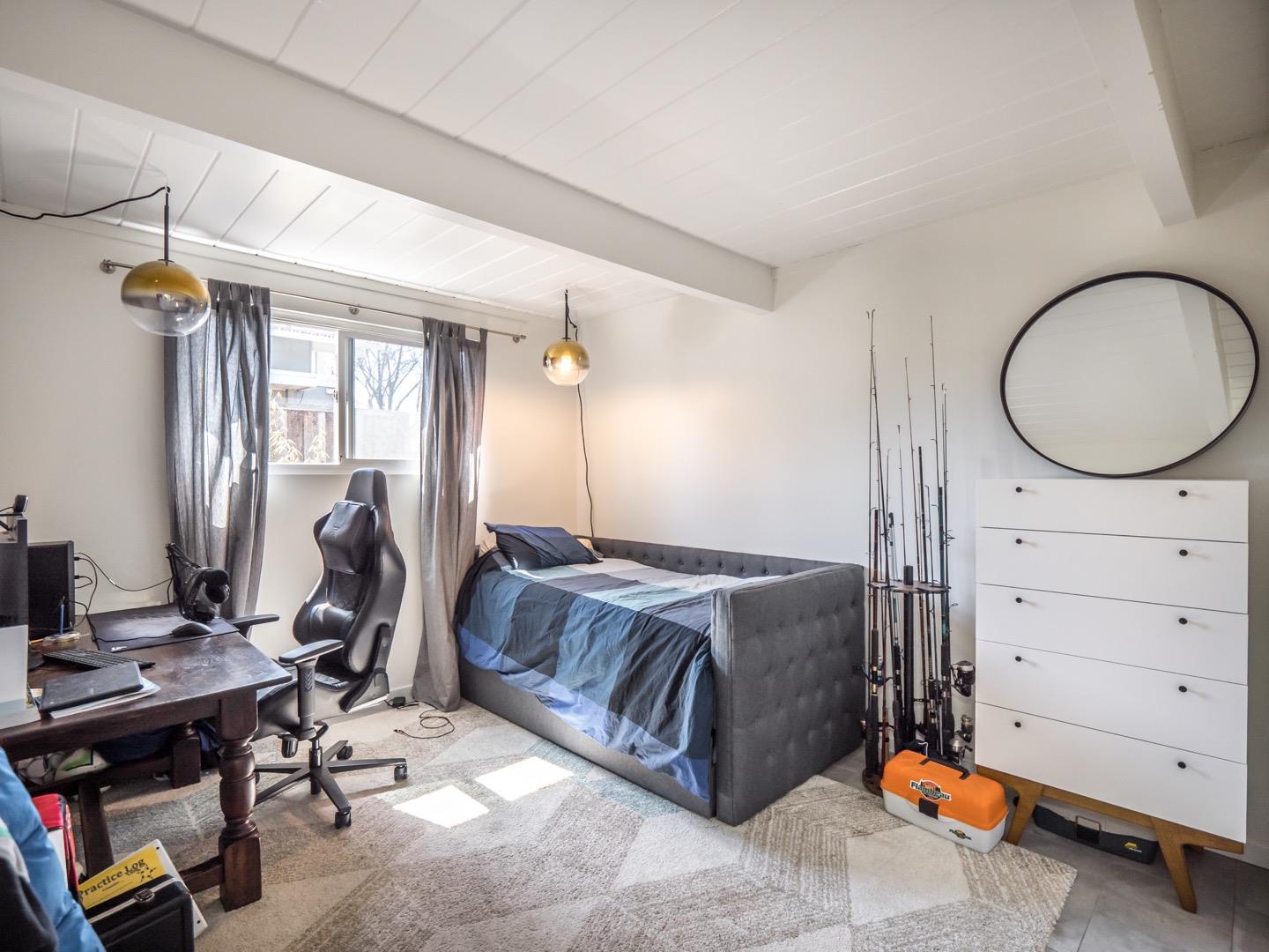 3449 Thomas Drive Palo Alto, CA 94303 - Photo 25 of 59 a bedroom with a bed and a chandelier