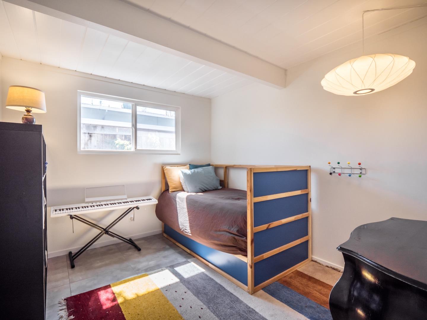 3449 Thomas Drive Palo Alto, CA 94303 - Photo 26 of 59 a bedroom with a bed and a chair