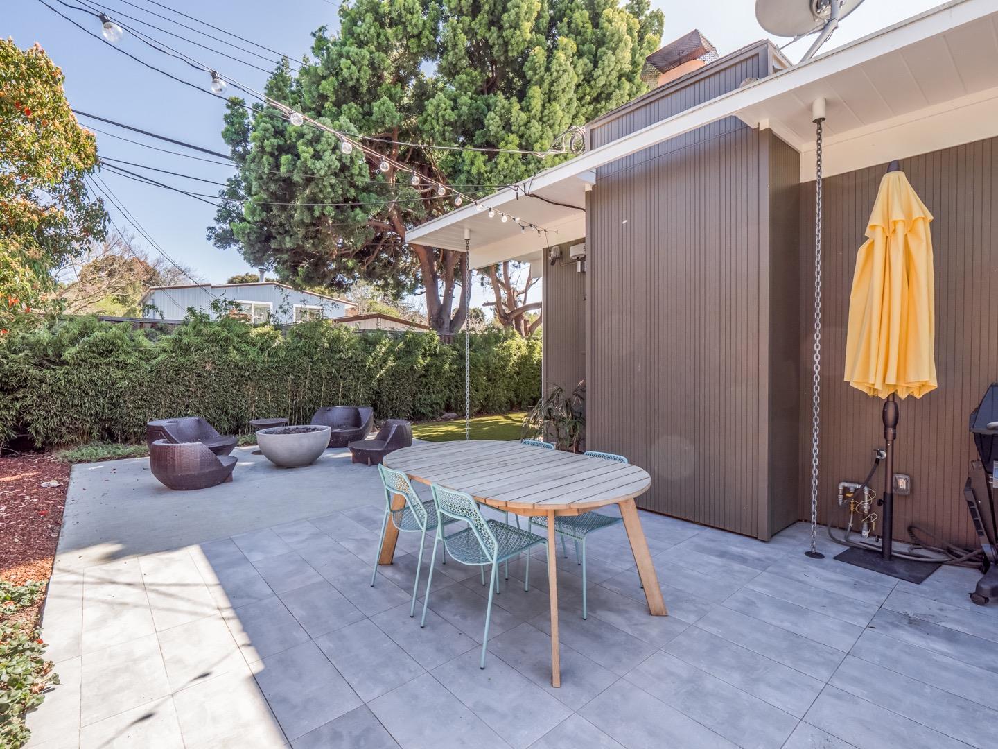 3449 Thomas Drive Palo Alto, CA 94303 - Photo 43 of 59 a view of a patio with a dining table and chairs and potted plants