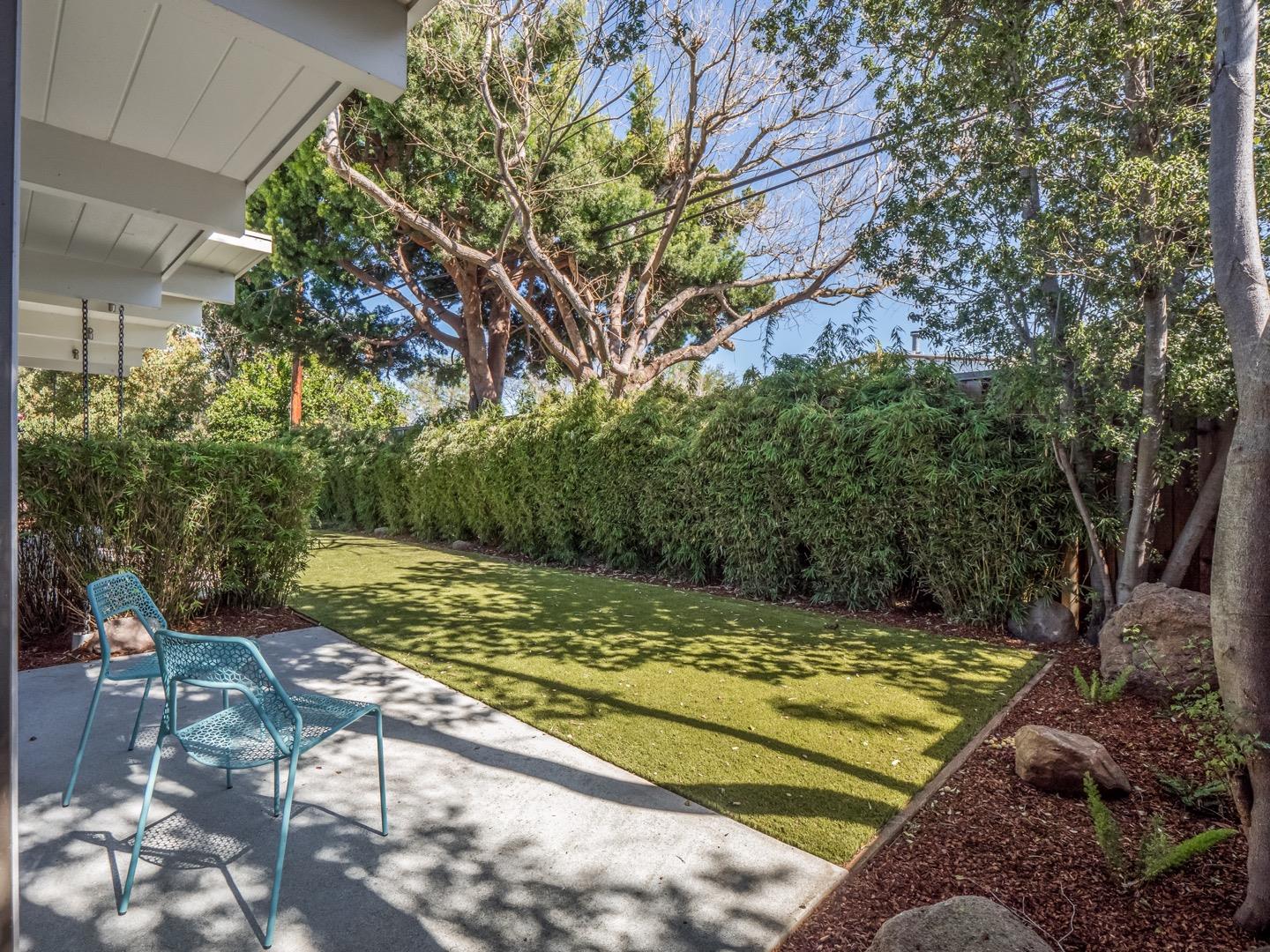 3449 Thomas Drive Palo Alto, CA 94303 - Photo 55 of 59 a view of a backyard with a table and chair and wooden fence