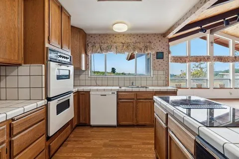 a kitchen with a sink stove and cabinets