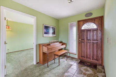 a view of a hallway with entryway and front door