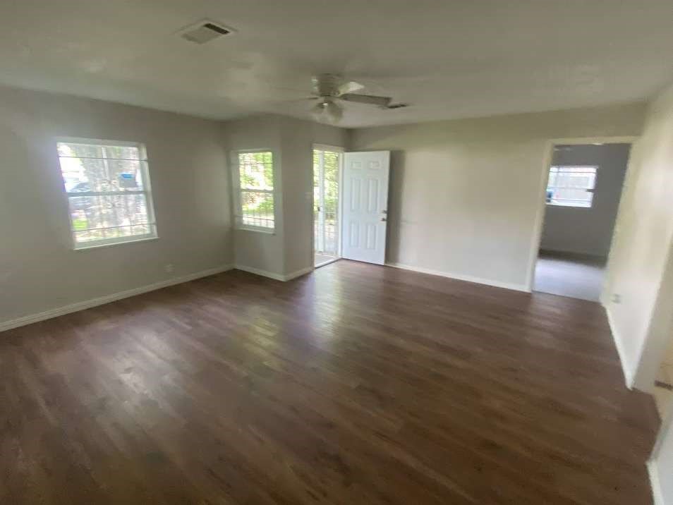 5131 Nassau Road Houston, TX 77021 - Photo 2 of 14 a view of an empty room with wooden floor and a window