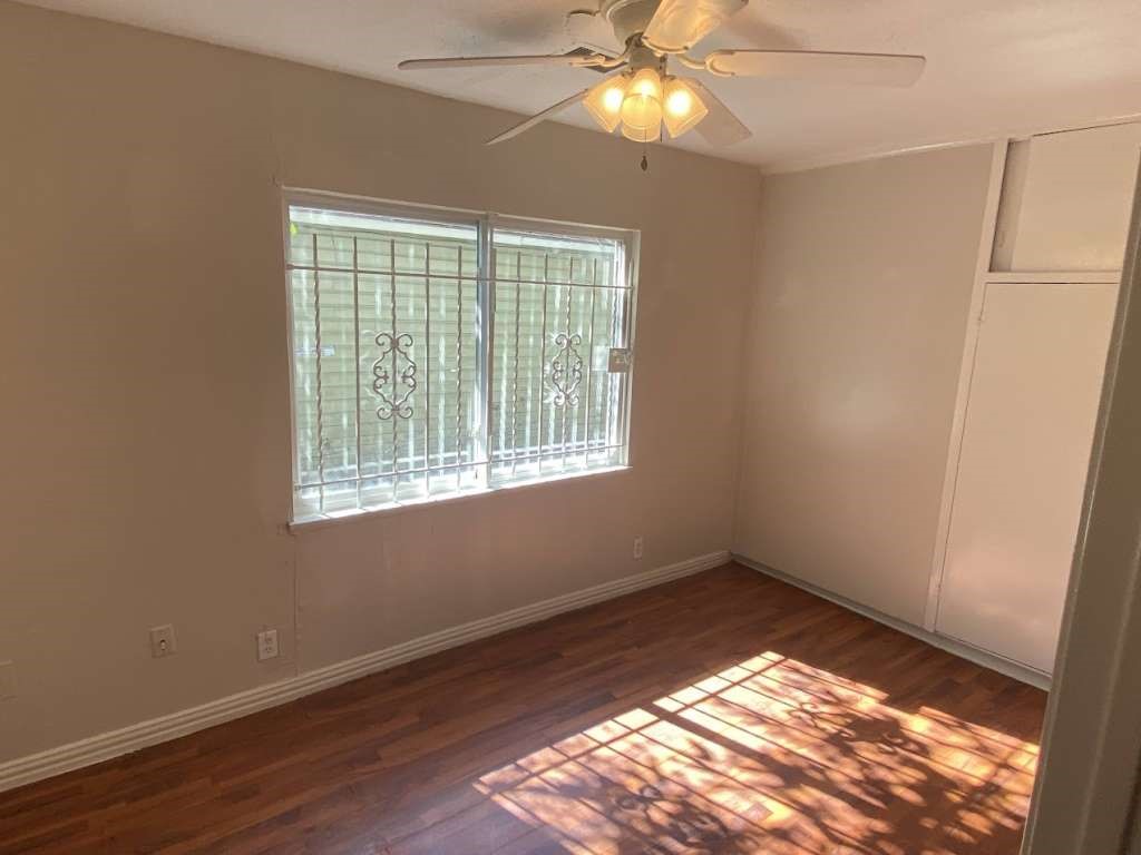 5131 Nassau Road Houston, TX 77021 - Photo 7 of 14 a view of an empty room with wooden floor and a window