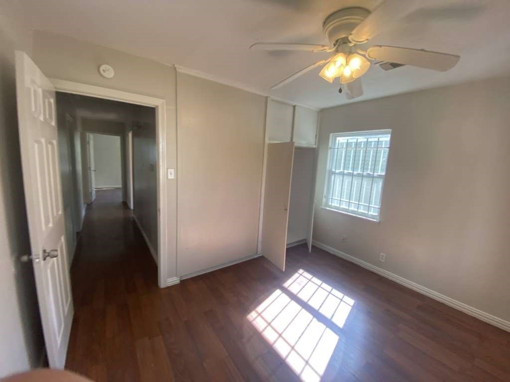 5131 Nassau Road Houston, TX 77021 - Photo 9 of 14 a view of an empty room with wooden floor and a window