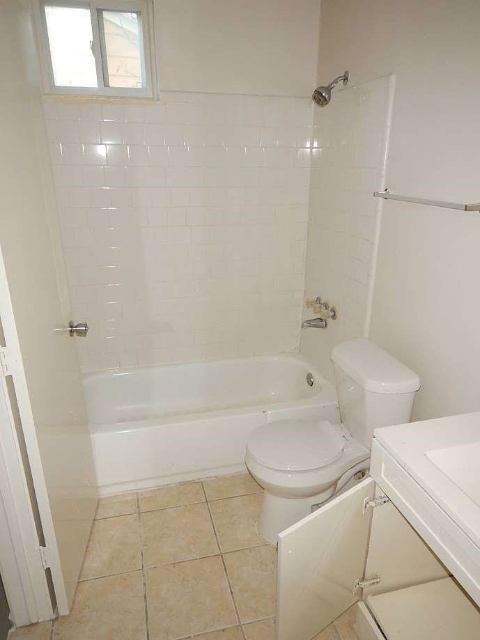 5131 Nassau Road Houston, TX 77021 - Photo 10 of 14 a bathroom with a toilet and a shower