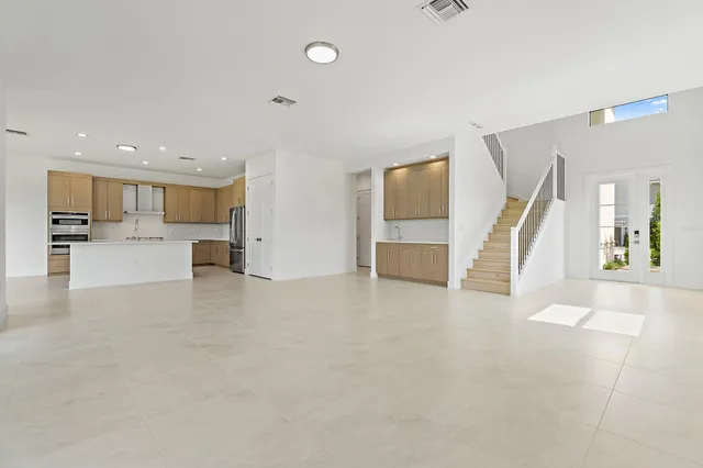 an empty room with a empty space and windows