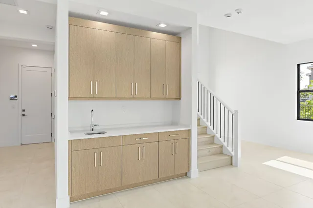 a large kitchen with stainless steel appliances granite countertop a large counter top a stove and a refrigerator