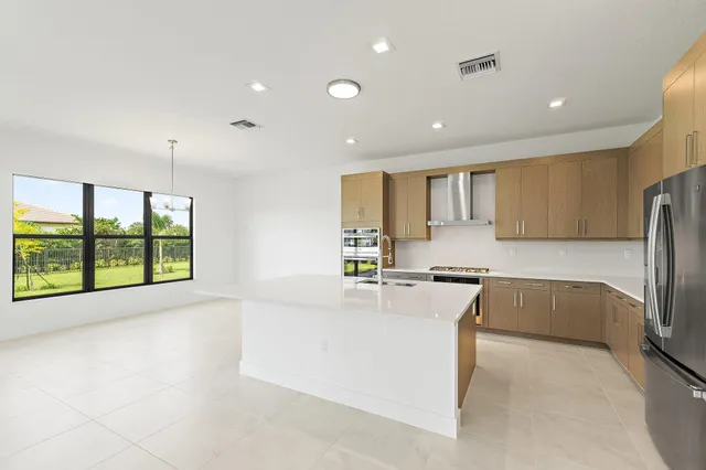 a kitchen with stainless steel appliances a refrigerator and a sink