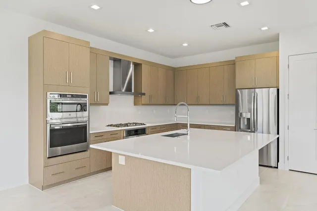 a kitchen with a sink stove and refrigerator